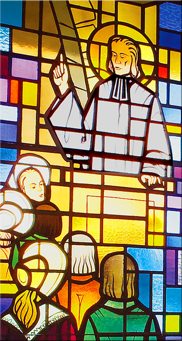 Stained glass window of Saint John Vianney preaching